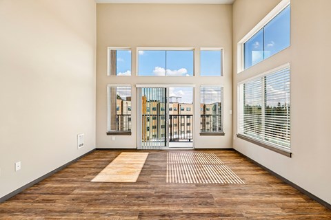 A room with a view of a cityscape through the windows.
