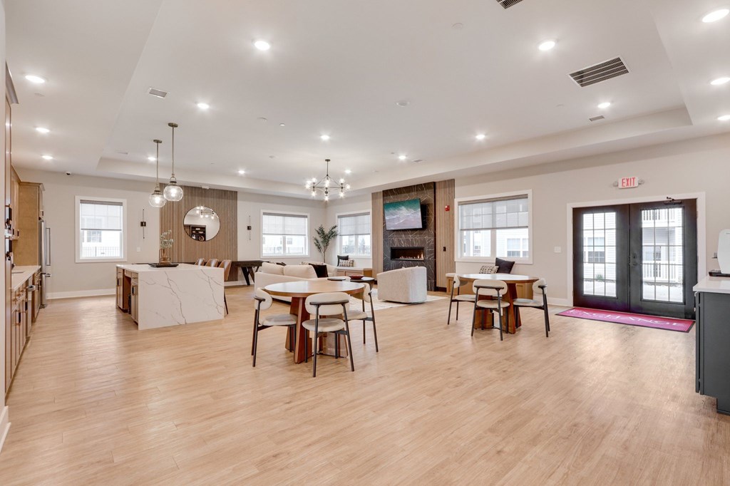 A spacious room with wooden floors and furniture.