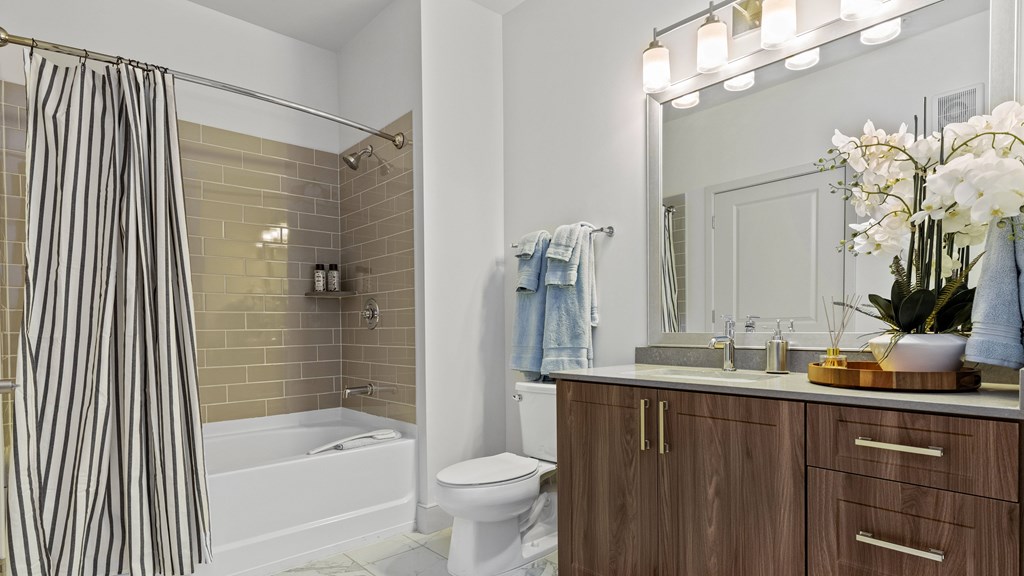 Bathroom with large vanity and tub with tile