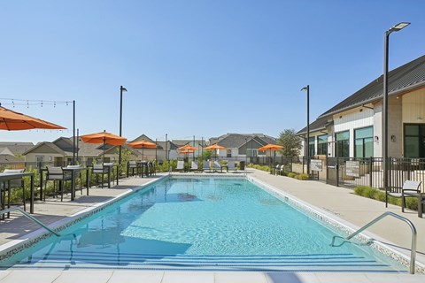 A large swimming pool with a metal fence around it.