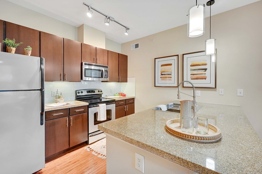 a kitchen with stainless steel appliances and granite counter tops