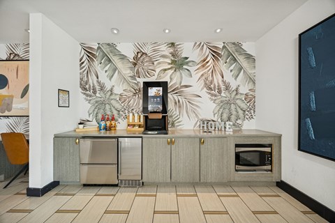 A kitchen with a wallpapered backdrop and a refrigerator with a digital display.