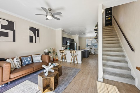 A living room with a brown couch and a wooden coffee table.