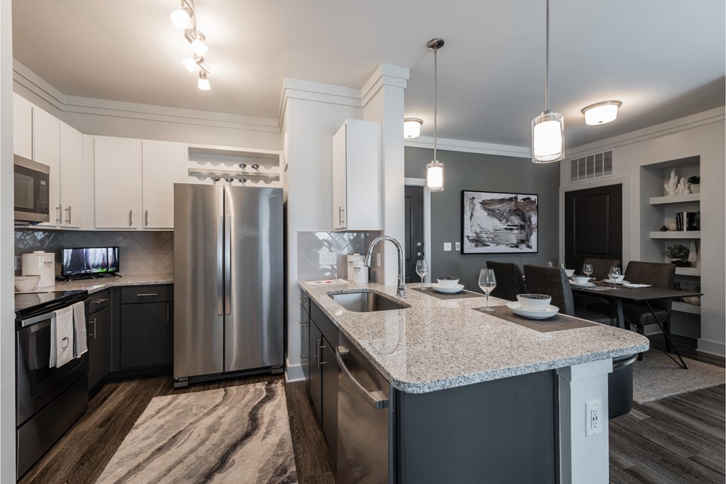 a kitchen with stainless steel appliances and granite counter tops
