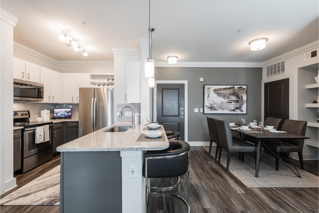 a kitchen and dining room with a marble counter top