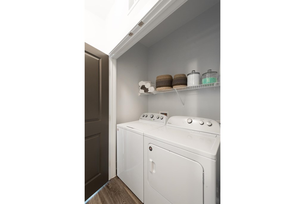 a small laundry room with a washer and dryer and a door