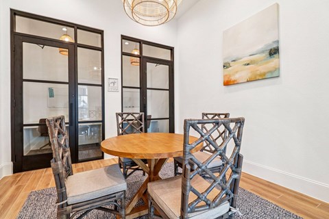 A dining room with a wooden table and chairs.