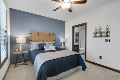 a bedroom with a bed and a ceiling fan