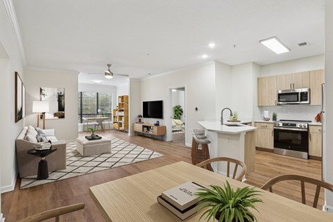 A modern open plan living and kitchen area with a dining table and chairs.