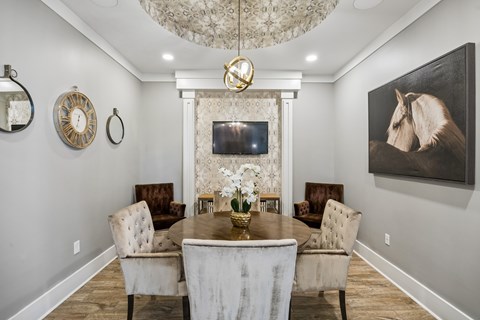 A dining room with a table set for four.