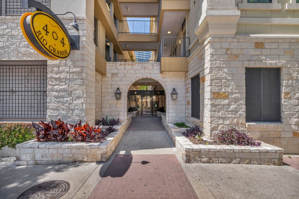 an entrance to a building with a courtyard and plants