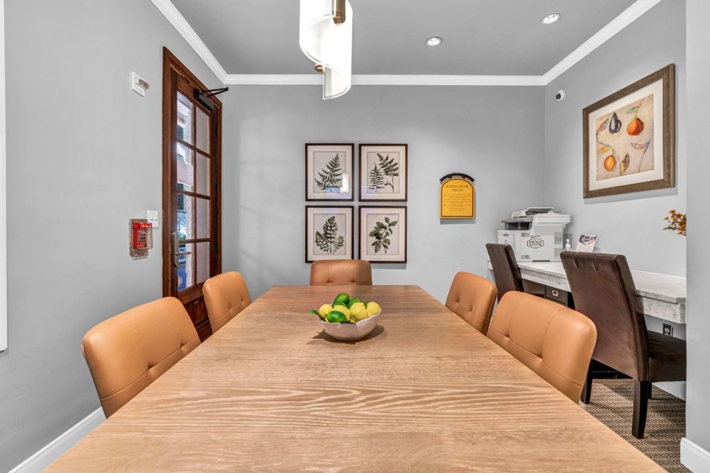 a dining room table with a bowl of fruit on it