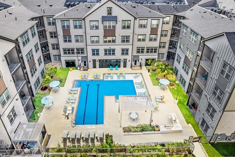 an aerial view of an apartment building with a swimming pool
