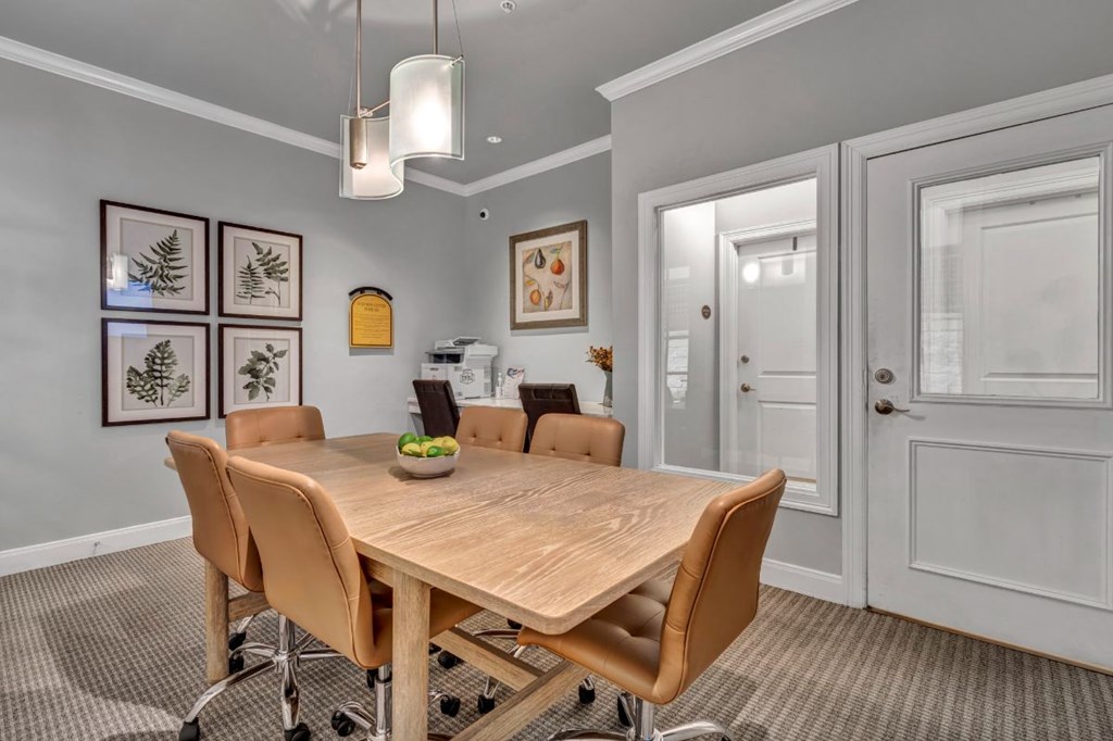 a dining room with a wooden table and chairs