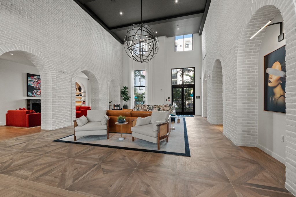 A modern living room with a wooden floor and white walls.