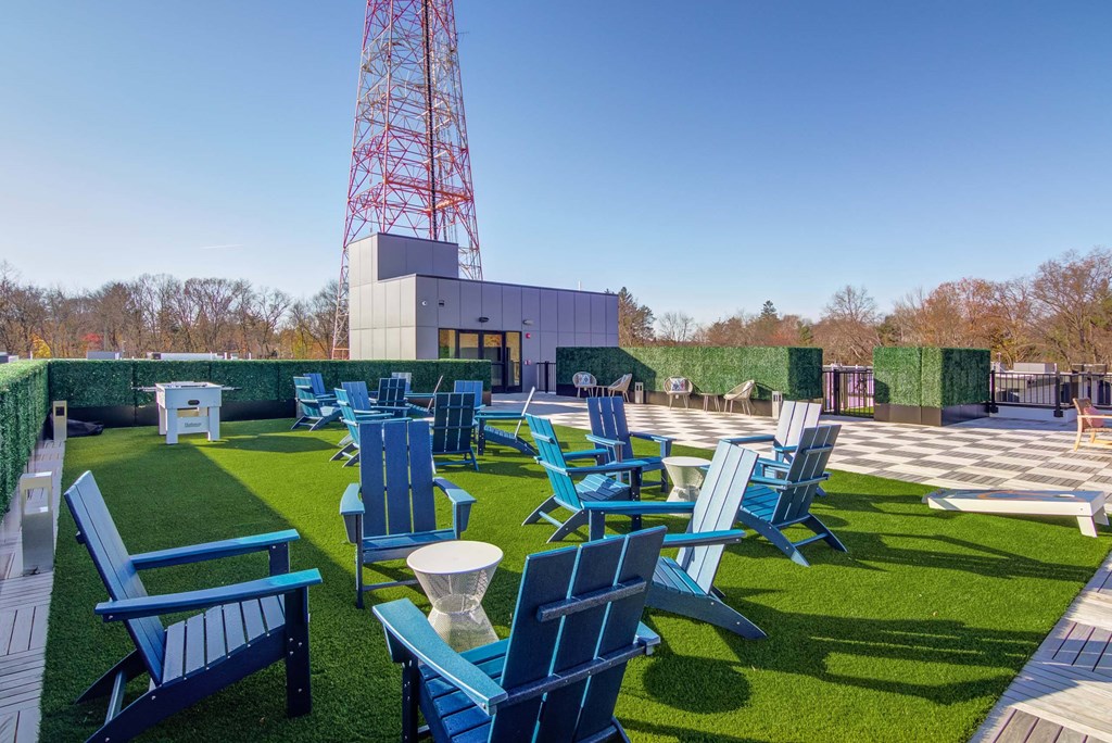 The Beacon rooftop game lawn with foosball, corn hole, and patio chair seating