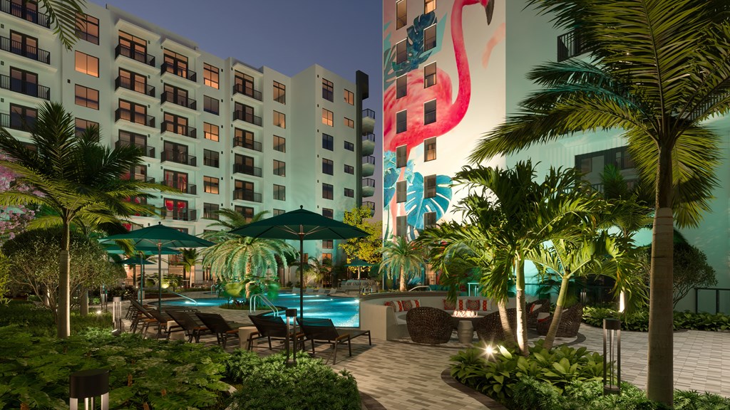 a hotel courtyard with a pool and palm trees