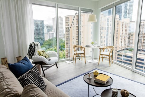 A living room with a couch, chairs, and a coffee table with a book on it.
