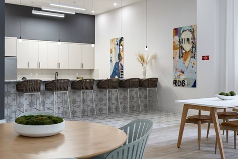 A modern kitchen with a dining table and chairs.