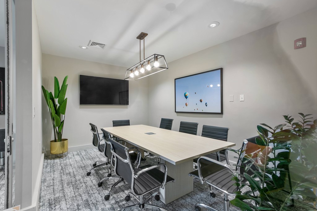 a conference room with a table and chairs