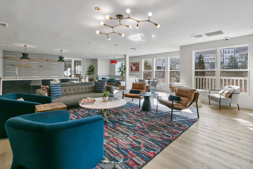 a living room with couches and chairs and a large rug