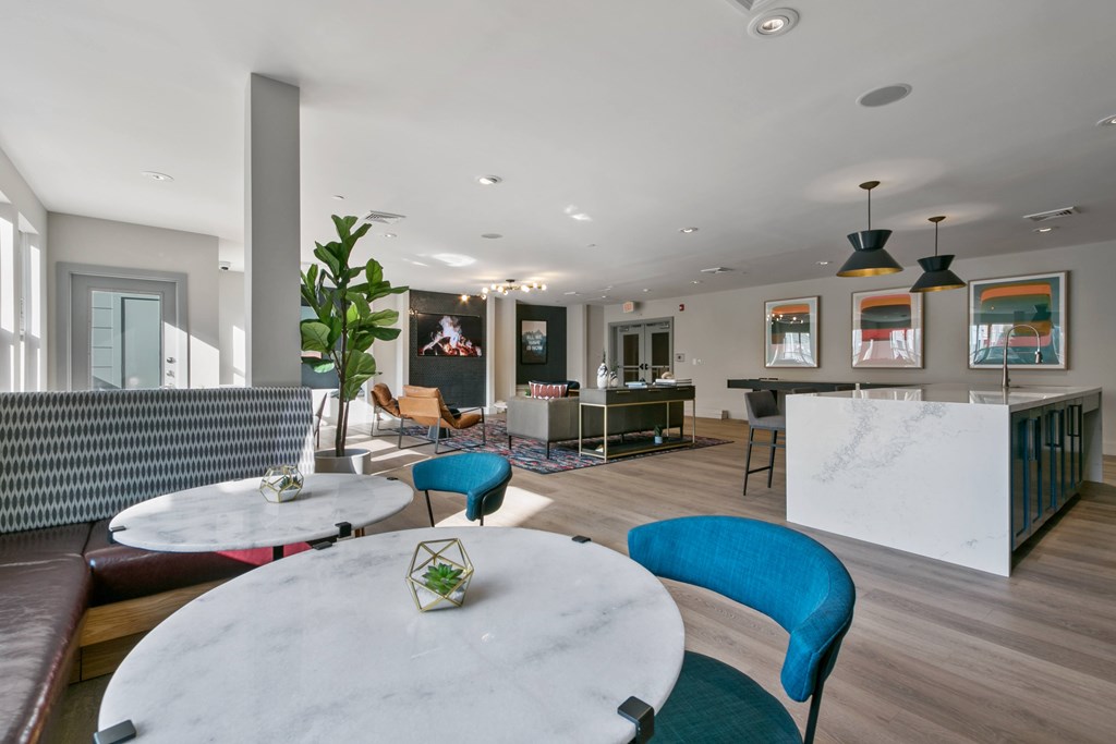 a living room with blue chairs and a white table