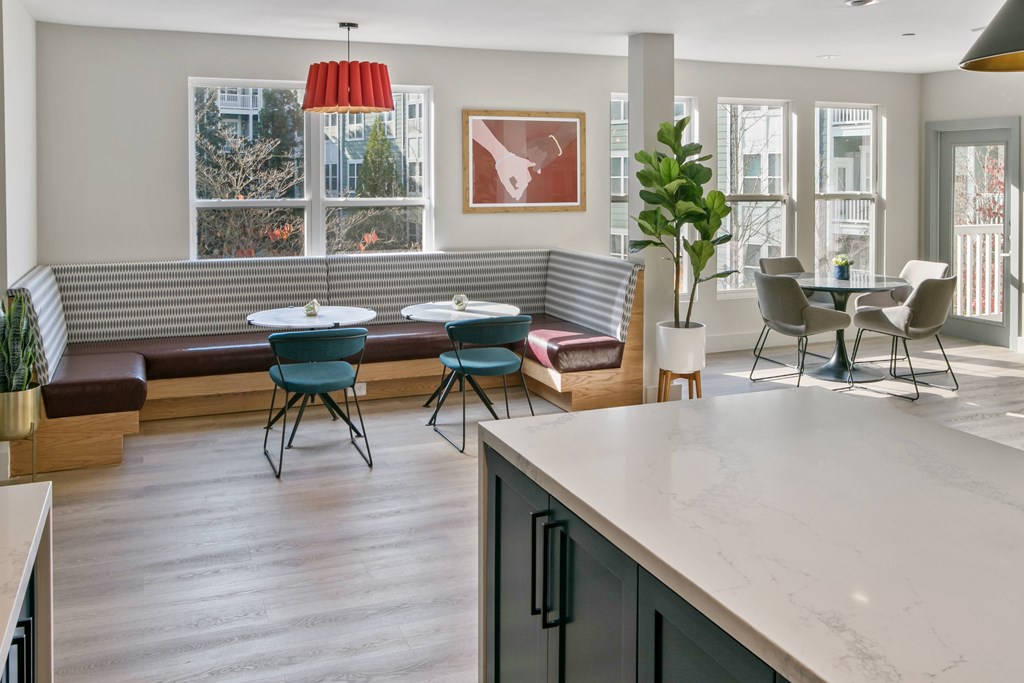 a living room with a table and chairs and a kitchen