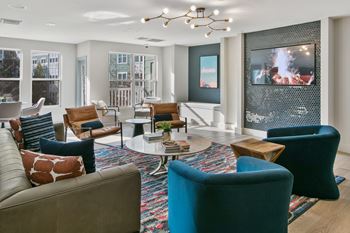 a living room with couches and chairs and a television