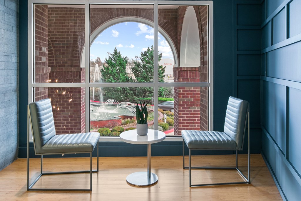 two chairs and a table in front of a window