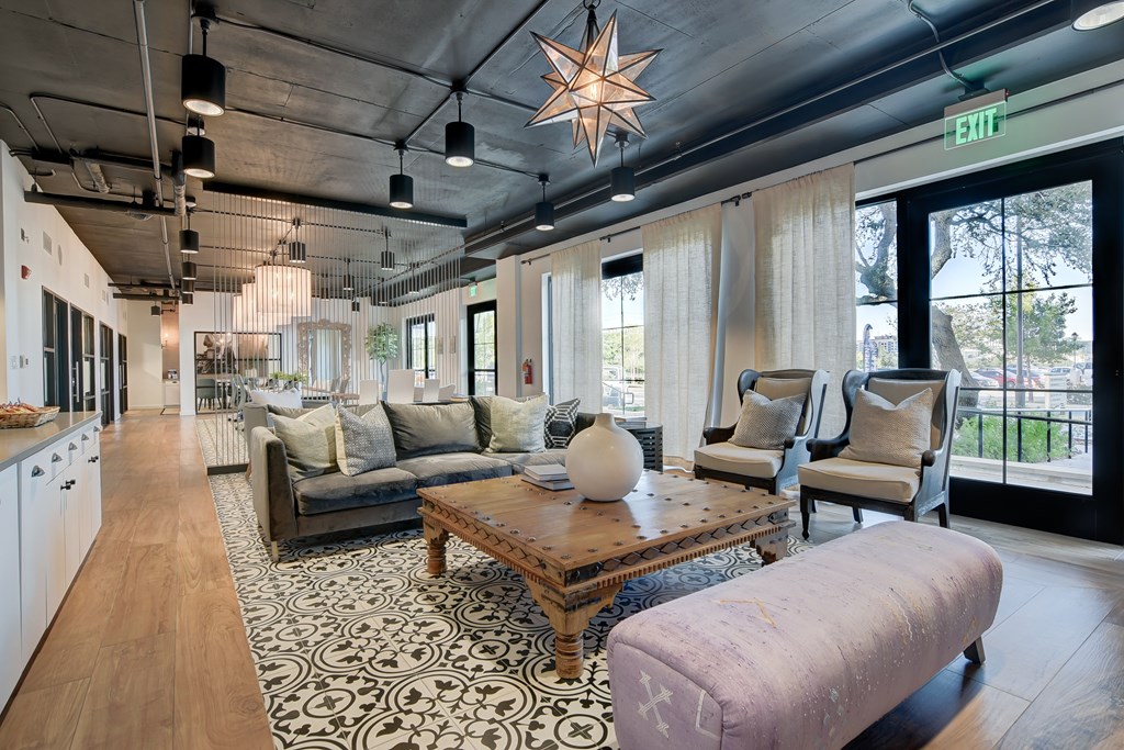 a living room with couches and chairs and a table