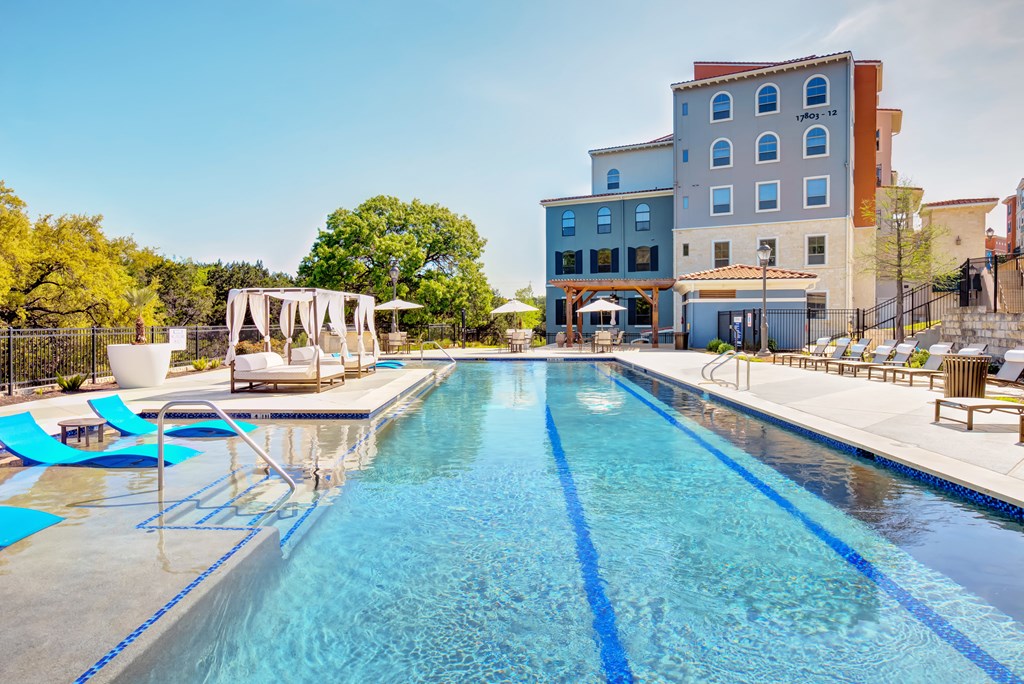 a swimming pool with a building in the background
