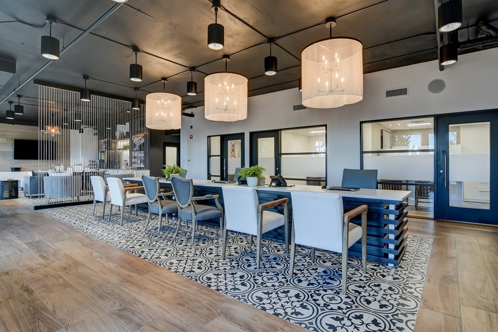 a dining room with blue and white chairs and a long table with chairs