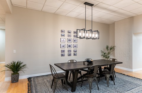 A dining room with a table and chairs.