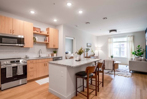 A modern kitchen with wooden cabinets and a white island.