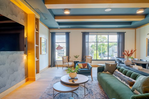 A living room with a green couch and a coffee table.