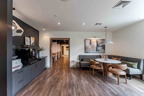 A modern kitchen with a dining table and chairs.