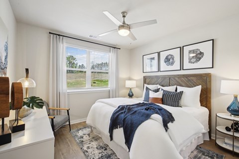 a bedroom with a large bed and a ceiling fan