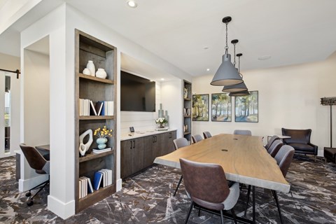a dining room and kitchen with a table and chairs