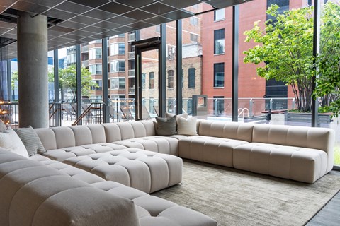 A white couch with a pillow is in the middle of a room.