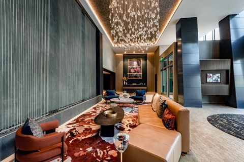A living room with a large rug and a long table with chairs.