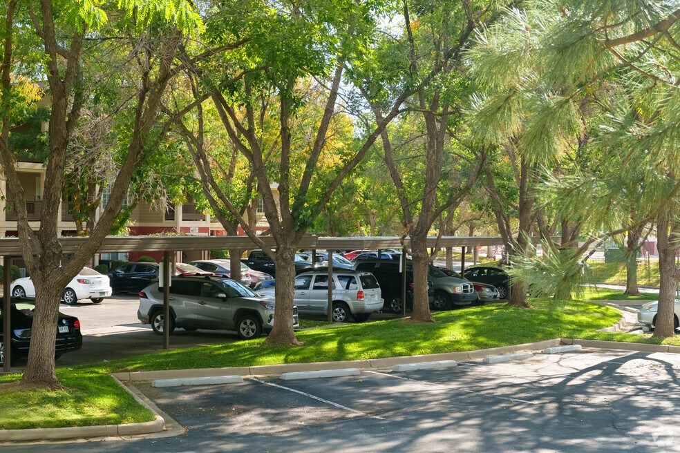 a parking lot filled with cars and trees