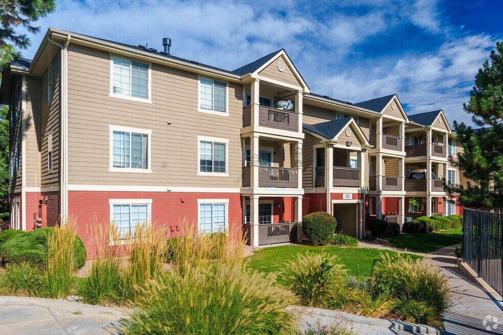 an apartment building with multiple balconies and a sidewalk