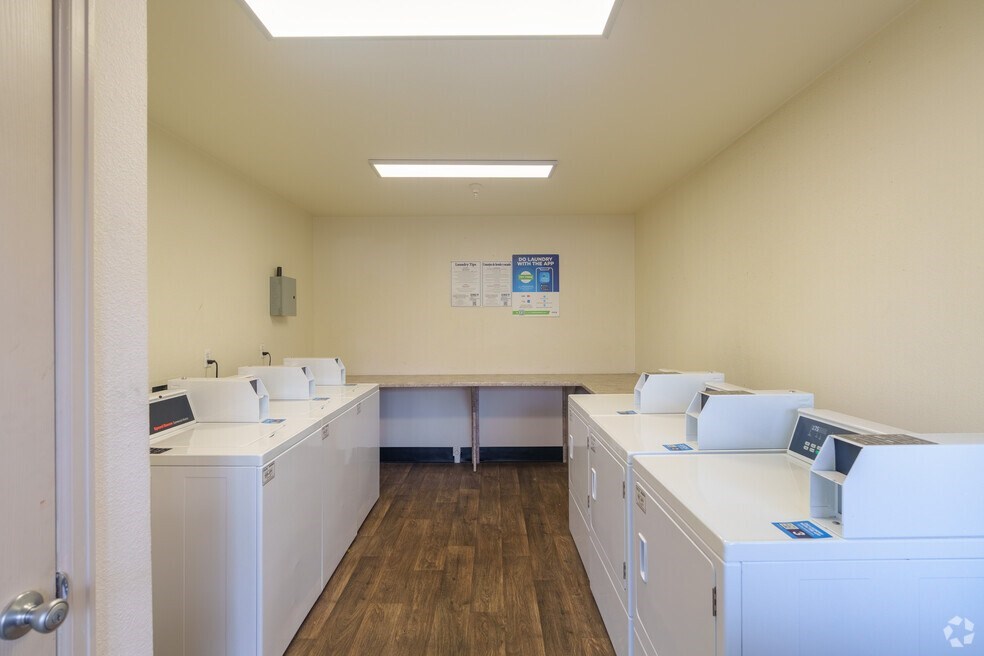 an empty room with washing machines and dryers