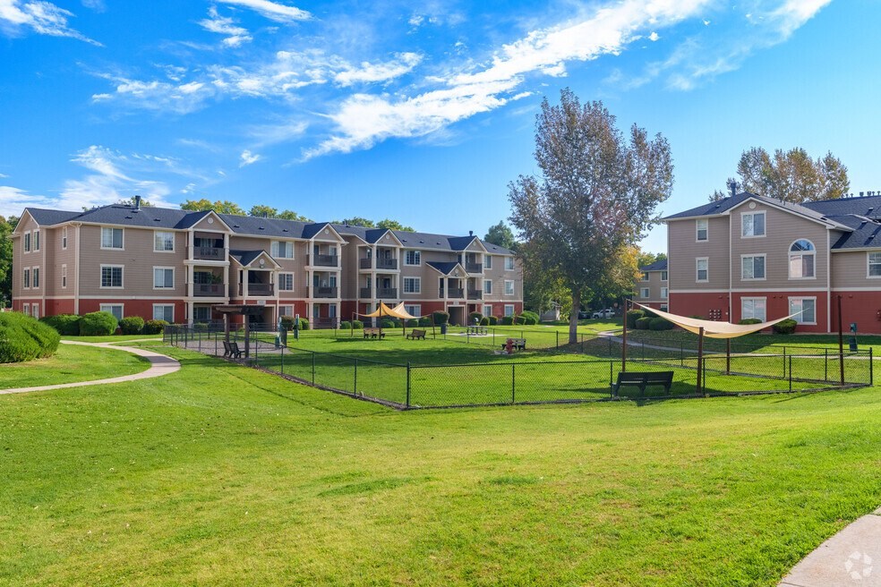 an apartment complex with a park and a playground