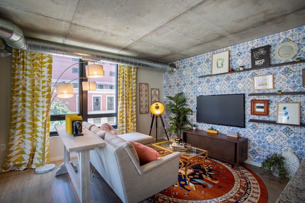 a living room with blue and yellow wallpaper and a couch