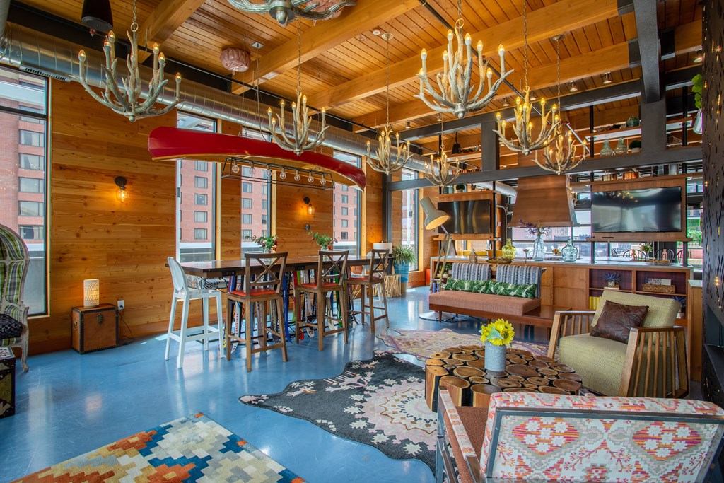 a living room and dining room with wooden ceilings and chandeliers