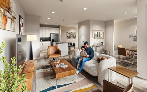 A man and a child are sitting on a couch in a modern living room.
