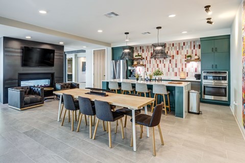 A modern kitchen with a dining table and chairs.