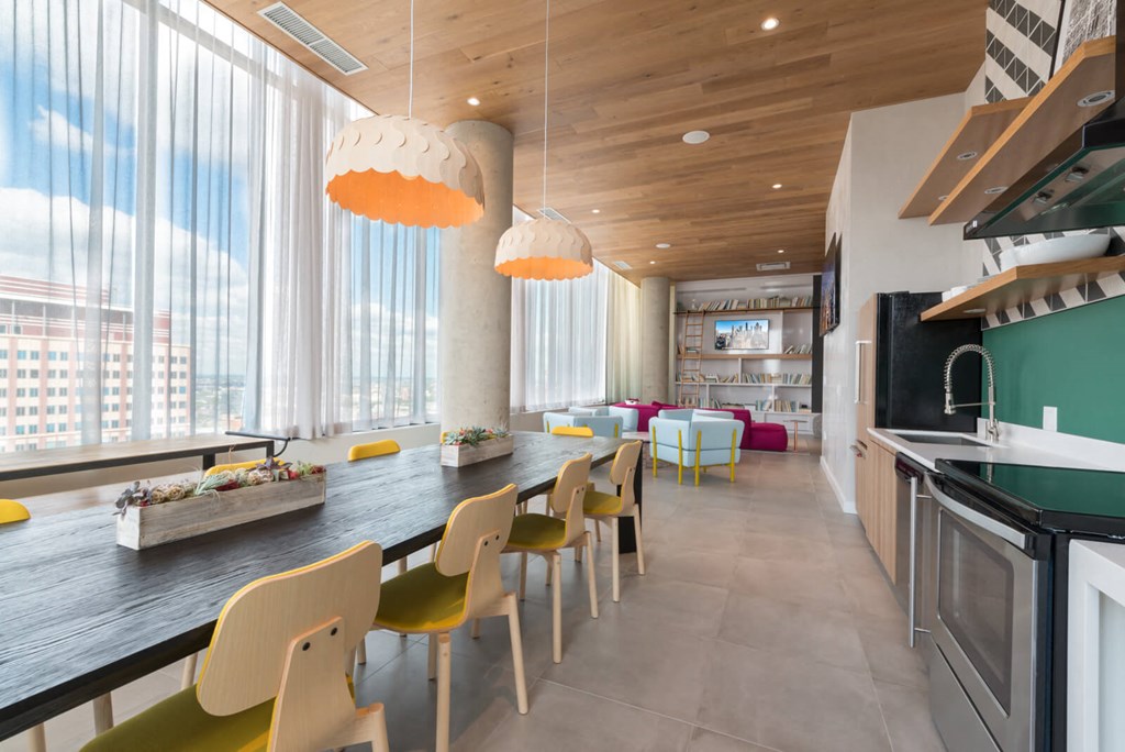 a long kitchen with a long table and chairs