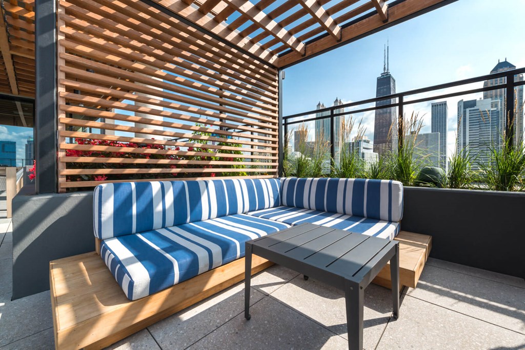 a patio with a blue and white couch and a table